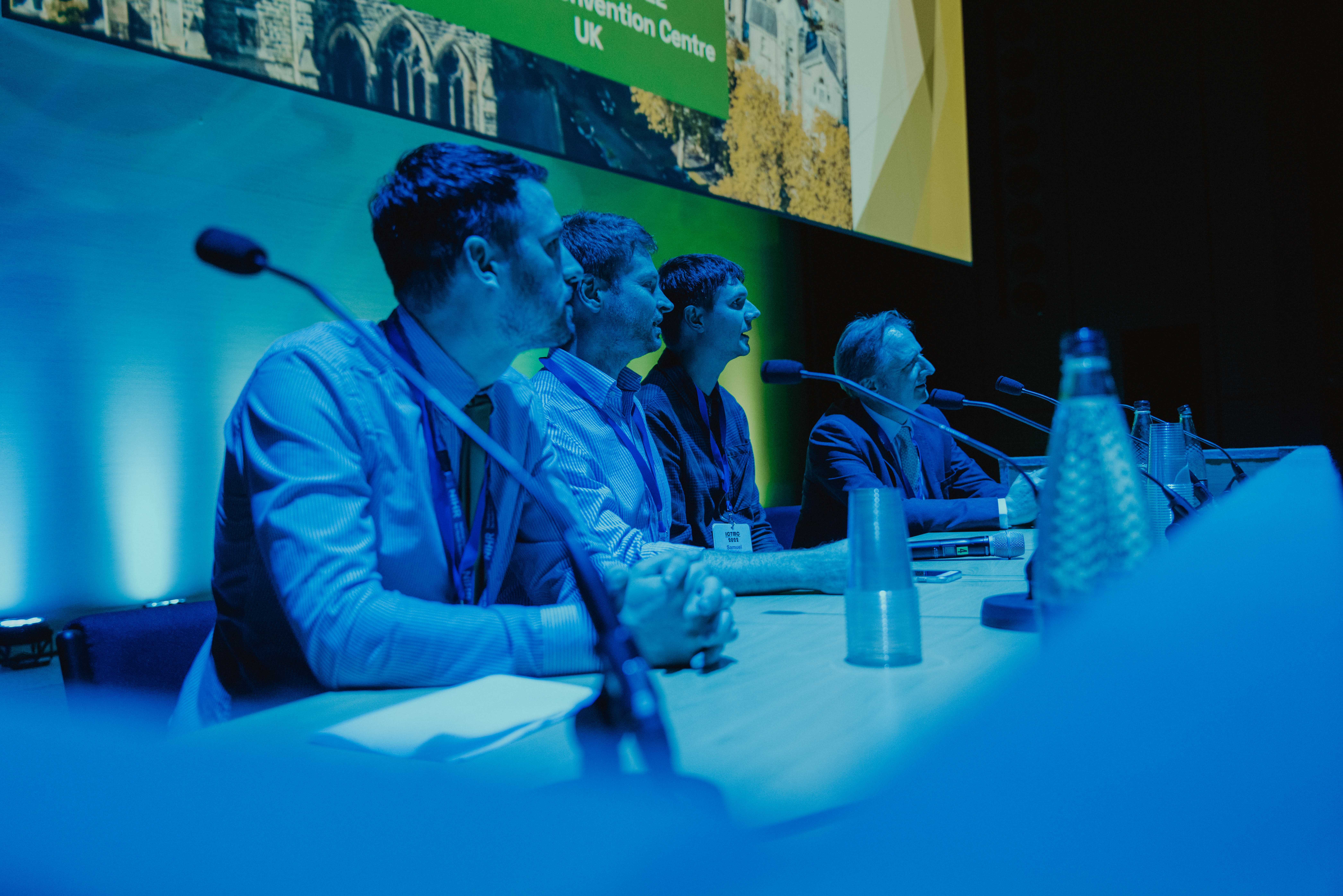 people in a panel at a conference