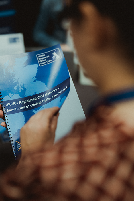 Image of someone reading the Monitoring Handbook produced by one of the Network's Operations Groups